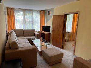 a living room with a couch and a table at Хотел Диамант Hotel Diamond in Balchik