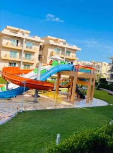 a water slide in a park in front of a building at شاليه 120/202 مارينا دلتا in Al Ḩammād