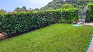 a garden with a gate and a hedge at Villa Michela in Costa Rei