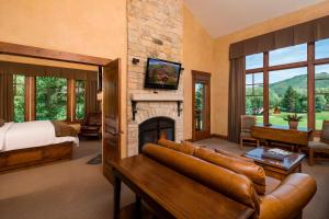 a living room with a fireplace and a bed at Hotel Park City, Autograph Collection in Park City