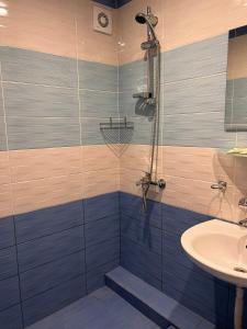 a bathroom with a shower and a sink at Хотел Диамант Hotel Diamond in Balchik +50 photos