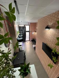 an office with plants and a brick wall at Grandera Apart`s - Carcaixent 24 in Valencia