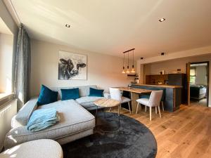 a living room with a couch and a table at Bergidyll in Oberstaufen