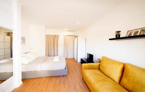 a living room with a couch and a bed at Apartment Ajuda Tagus (ground floor) in Lisbon