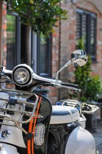 a motorcycle parked on the side of a street at Queensgate Holiday Cottage Beverley with Parking in Beverley
