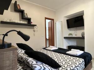 a bedroom with a bed with a lamp and a tv at SognoNarni in Narni