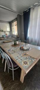 a dining room table with chairs and a tableablish at Εξοχικό ROXANI in Ambelákia