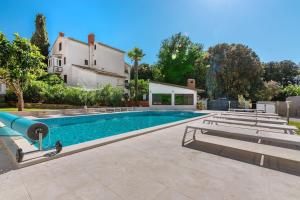 a swimming pool in front of a house at Villa Vera in Banjole