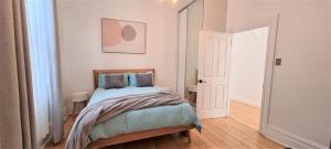 a small bedroom with a bed and a door at Live - Play - Stay - East Geelong in Geelong