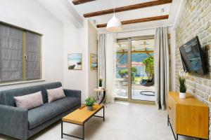 a living room with a couch and a tv at Brothers Apartments in Skala Potamias