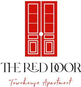 eine rote Tür mit dem roten Innenlogo in der Unterkunft The Red Door Townhouse Apartment in Ardara