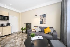 a living room with a couch and a table at Apartament 110 w centrum Gdyni ProstyWynajem in Gdynia