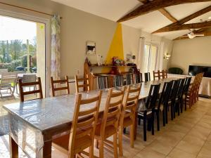 a dining room with a large table and chairs at Les Gites de la Richardiere in Saint-Révérend