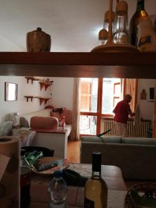 a man standing in a living room looking out the window at appartamento Cima in Fiumalbo