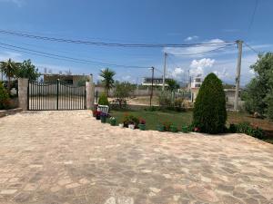 a patio with a fence and some plants and flowers at Villas Ermali in Ksamil