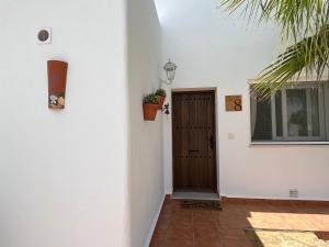 a hallway of a house with a door and a window at Casa la Vida - Golf villa with private pool in Alhama de Murcia +22 photos