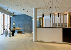a lobby with a reception counter and a table at Naturhotel & Chalets Euler in Neuschönau