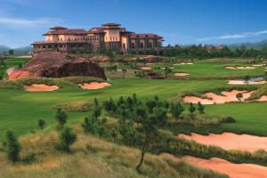 a view of a golf course with a large building at Sheraton Qingyuan Lion Lake Resort in Qingyuan