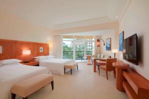 a hotel room with two beds and a flat screen tv at Sheraton Sanya Yalong Bay Resort in Sanya