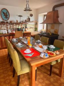 a wooden table with food on it in a kitchen at b&b Antiche Pietre in Bollengo