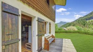 an open door of a house with a porch at Chalet Jumbaz in Seytroux