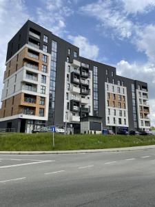 a large building on the side of a road at Apartment Rzeszów Karolina in Rzeszów