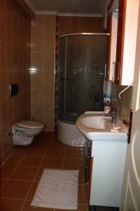 a bathroom with a toilet and a shower and a sink at Star apartments in Trabzon