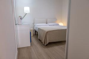 a bedroom with a bed and a mirror at Teatro Apartments Mondello in Palermo