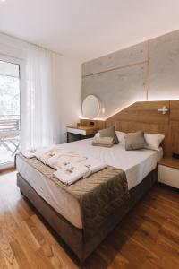 a large bed in a bedroom with a large window at ZLATIBOR HIGHLAND in Zlatibor