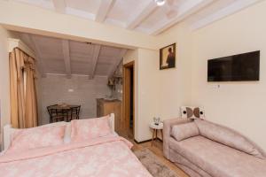 a living room with a bed and a couch at Ostro&scaron;ke grede in Nik&scaron;ić