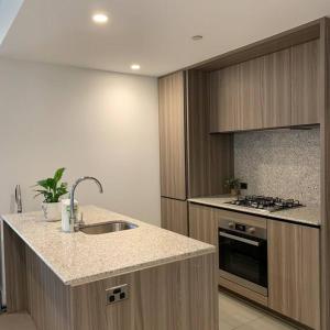 a kitchen with a sink and a stove at CBD Spacious Two Bedrooms Apartment in Melbourne