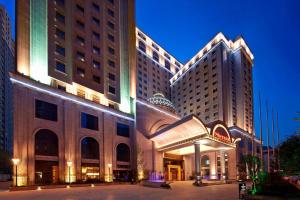 a large building with a building with lights on it at Sheraton Xi'an North City Hotel in Xi'an