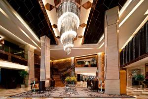 a lobby with a large chandelier in a hotel at Sheraton Xi'an North City Hotel in Xi'an