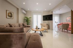 a living room with a couch and a table at NK Luxury Apartments in Preveza
