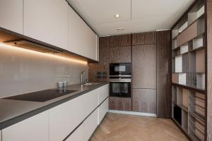 a kitchen with white cabinets and a counter top at Battersea Mall apartment in London