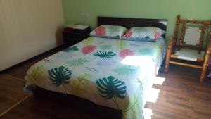 a bed with a comforter with flowers on it at Sevan Garden Complex in Sevan