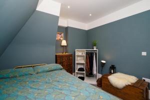 a blue bedroom with a bed and a dresser at Pearl Chambers in Leeds City Centre in Leeds