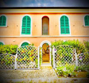 a house with a gate in front of it at Conero Casa - Marcelli di Numana in Piazzale Eolie 7 in Marcelli