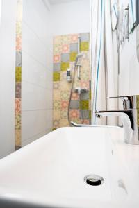 a bathroom with a white sink and a shower at Hotel Berliner Hof in Remscheid