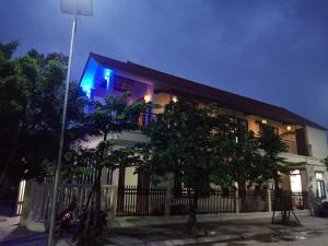 a building with a blue sign on the side of it at Xuka Homestay in Hue