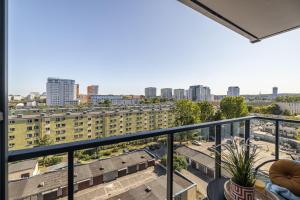 a balcony with a view of a city at Marina Primore - Hampton Apartments in Gdańsk