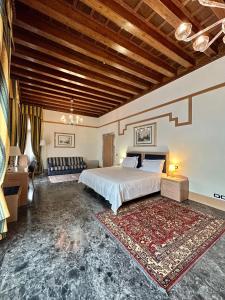 a large bedroom with a bed and a couch at Foscari Palace in Venice