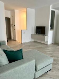 a living room with a couch and a flat screen tv at Appartamento Borgomarina in Cervia