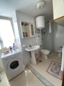 a bathroom with a washing machine and a sink at La Casa dei Sogni in Procida