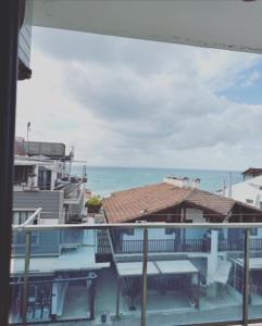 a view of the ocean from the balcony of a building at PİNK POİNT APART in Didim