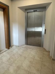 a elevator with a metal door in a room at PİNK POİNT APART in Didim