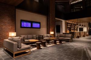 a lobby with couches and tables and a window at Four Points by Sheraton Nagoya, Chubu International Airport in Tokoname