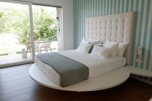 a bedroom with a large bed with a large window at Elle Ecoholiday in Malcesine