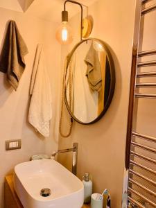 a bathroom with a white sink and a mirror at Miini loft di pregio a Roma Nord- Ponte Milvio in Rome