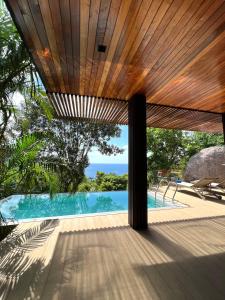 a view of a swimming pool from a house at Tanote Villa SHA Extra Plus in Koh Tao